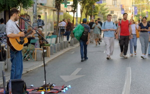 Boy playing guitar on street